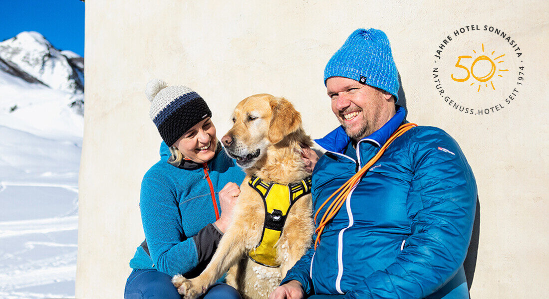 Silvia and Peter with their dog Luke in a winter wonderland.