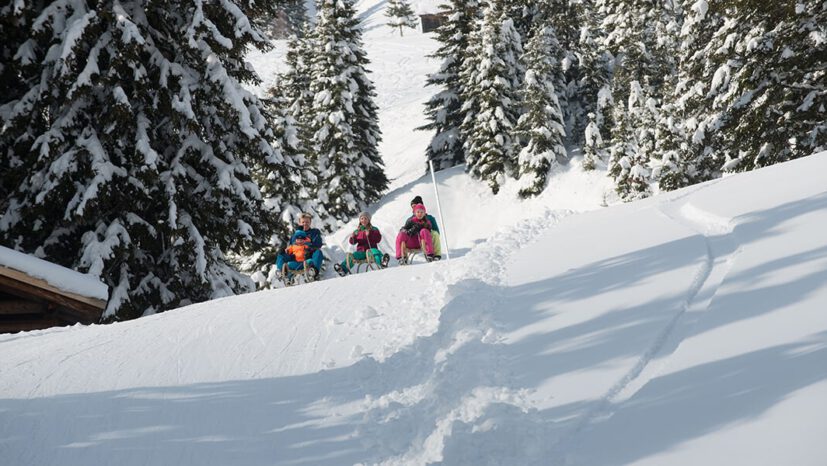 Family sledding in Damüls.