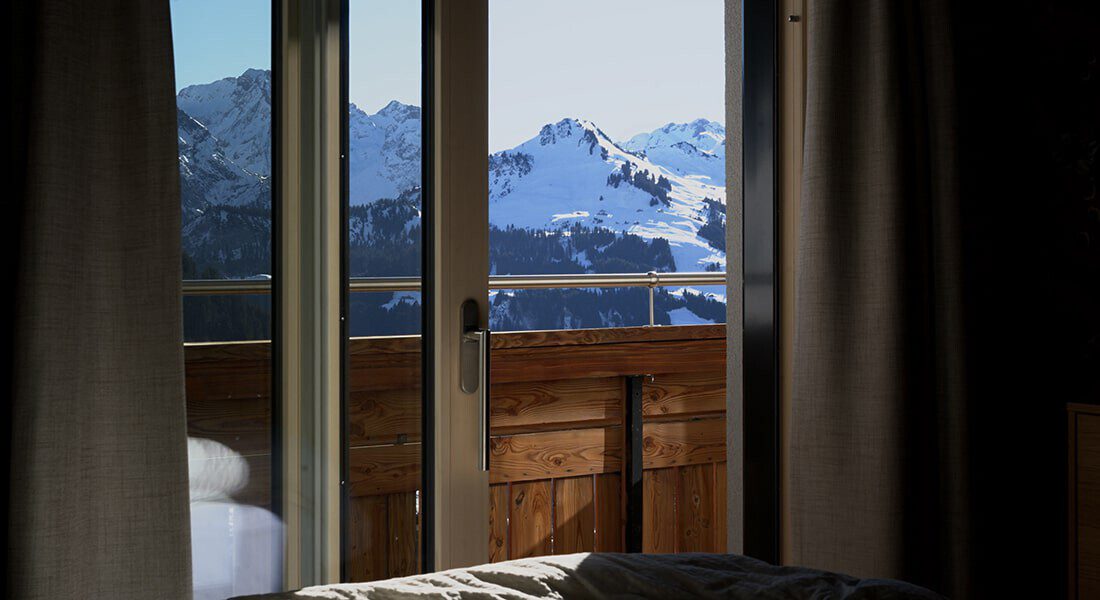 Fantastic view of the snowy mountain scenery directly from the bed.